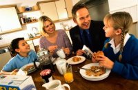 Join your kids at the breakfast table to encourage healthy eating habits.