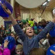 photo - Bridget McGee, 8, reaches for the balloons during the balloon drop at the Noon Year's Eve celebration Wednesday, Dec. 31. 2014, at the Olympic Training Center in Colorado Springs. The celebration was sponsored by the Pikes Peak Children's Museum. (The Gazette, Christian Murdock)