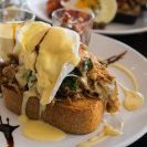 Pulled pork Benedict with two poached eggs,  wilted spinach,  onion jam,  hollandaise and thick toast (AU$19.50)