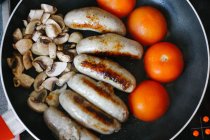 Sausages, tomatoes, and mushrooms
